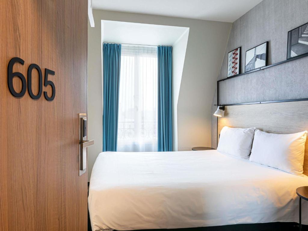 Кровать или кровати в номере ibis Paris Boulogne Billancourt