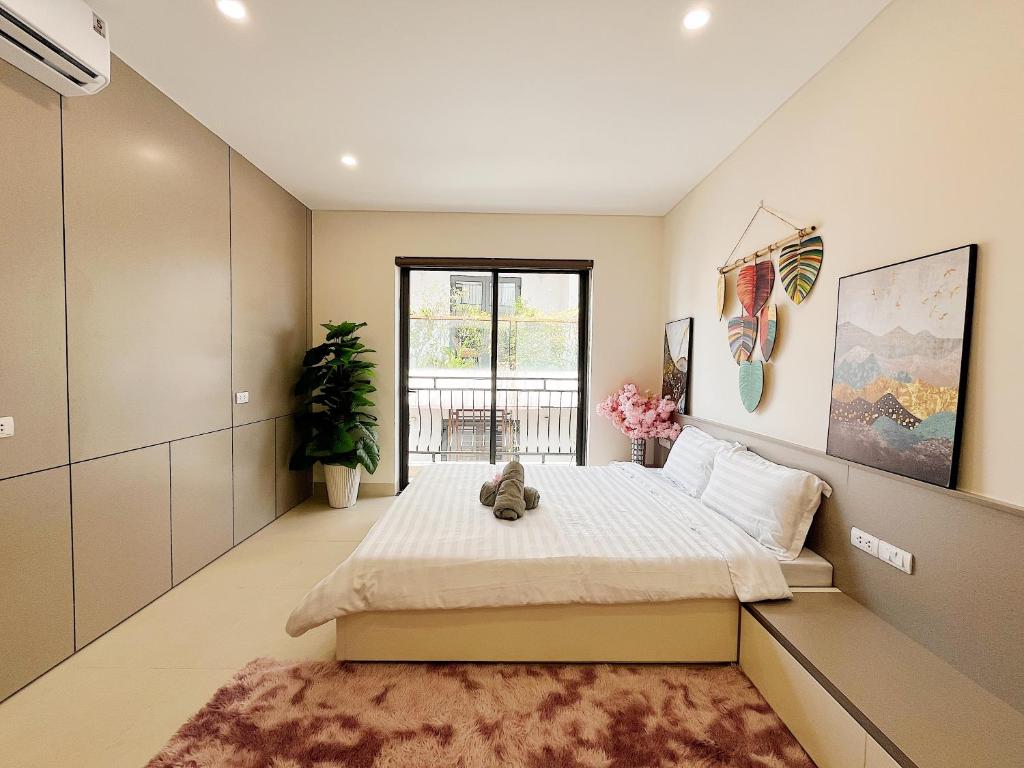 a bedroom with a large bed and a window at Soin Riverside Apartment in Hanoi