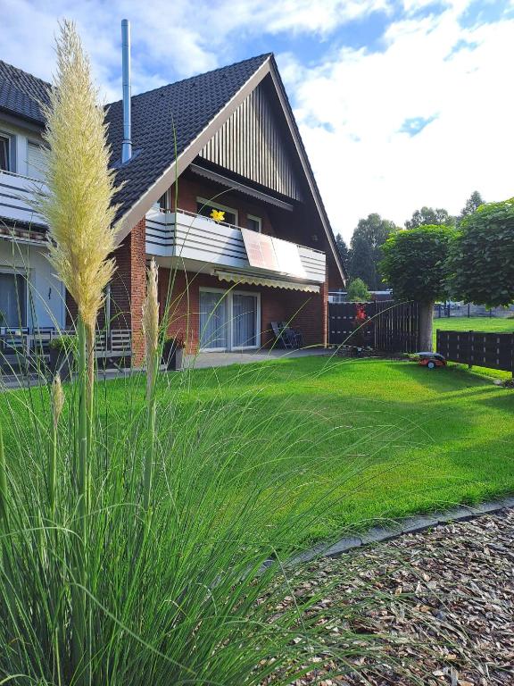 a house with a grass field in front of it at In der Heide in Löhne