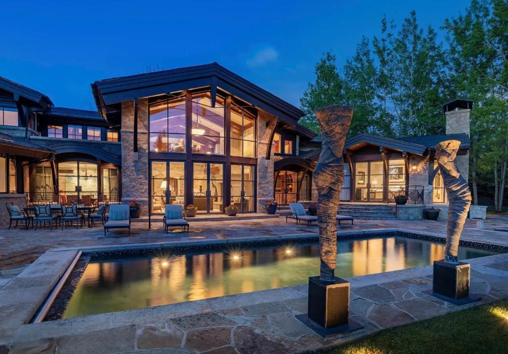 a home with a swimming pool and a house at Villa Noor in Aspen