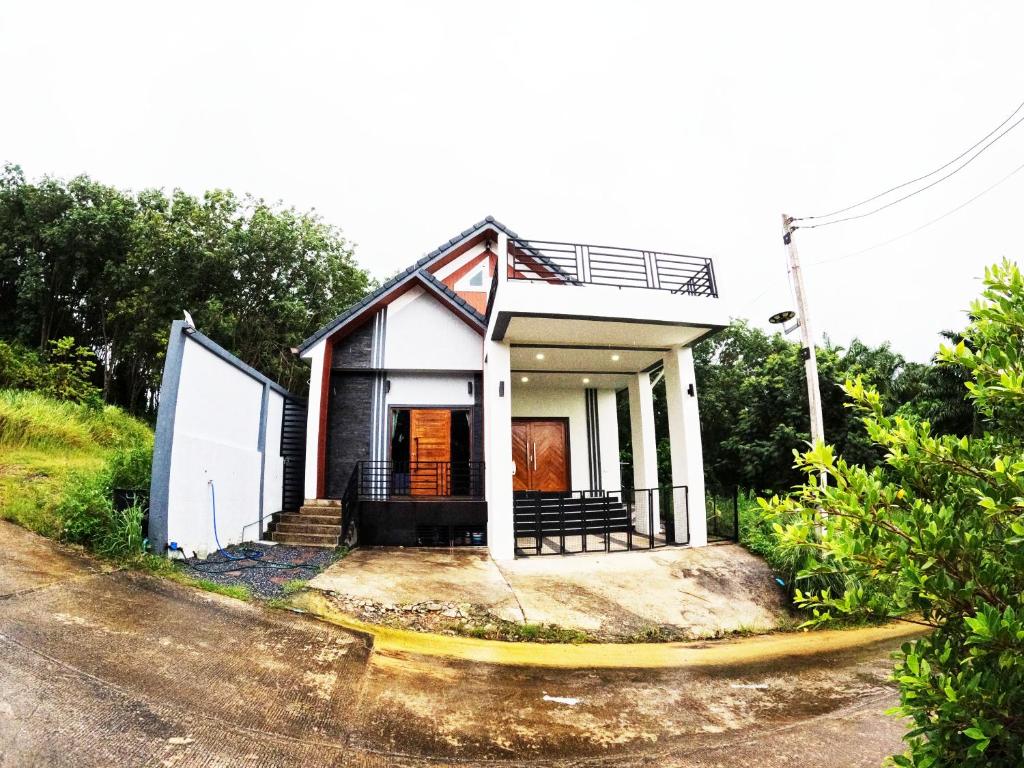 a small house sitting on the side of a road at Krabi Top Sea Hill Villa in Klong Muang Beach