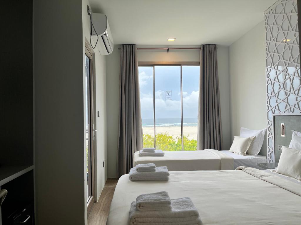 Postel nebo postele na pokoji v ubytování Avyanna Gulhi Beach Hotel