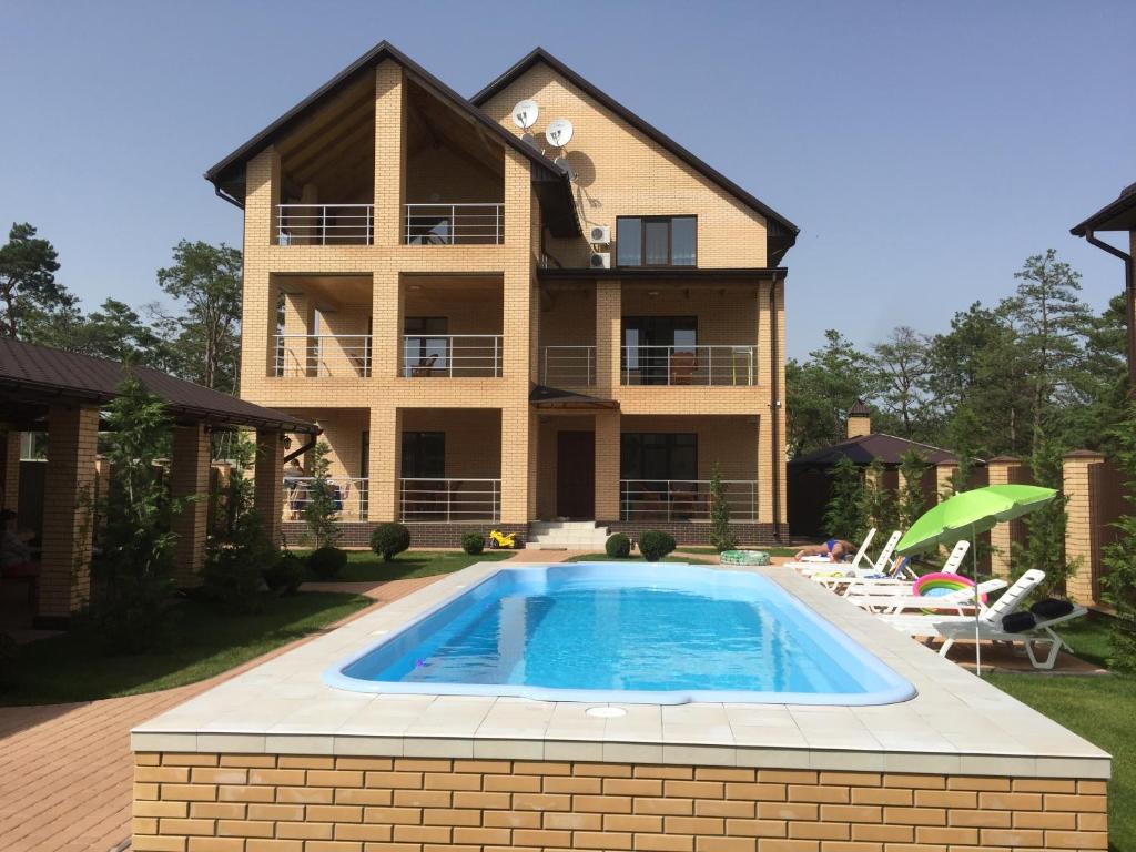 a house with a swimming pool in front of it at Admiral 2 in Koblevo