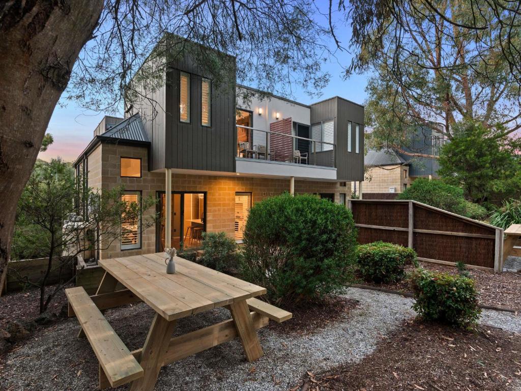 a house with a picnic table in front of it at The Sebel Creswick Forest Resort in Creswick