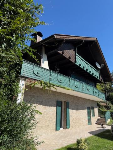 a building with a blue balcony on top of it at Ferienhaus Maximilian, Ideal für Familien in Gamlitz