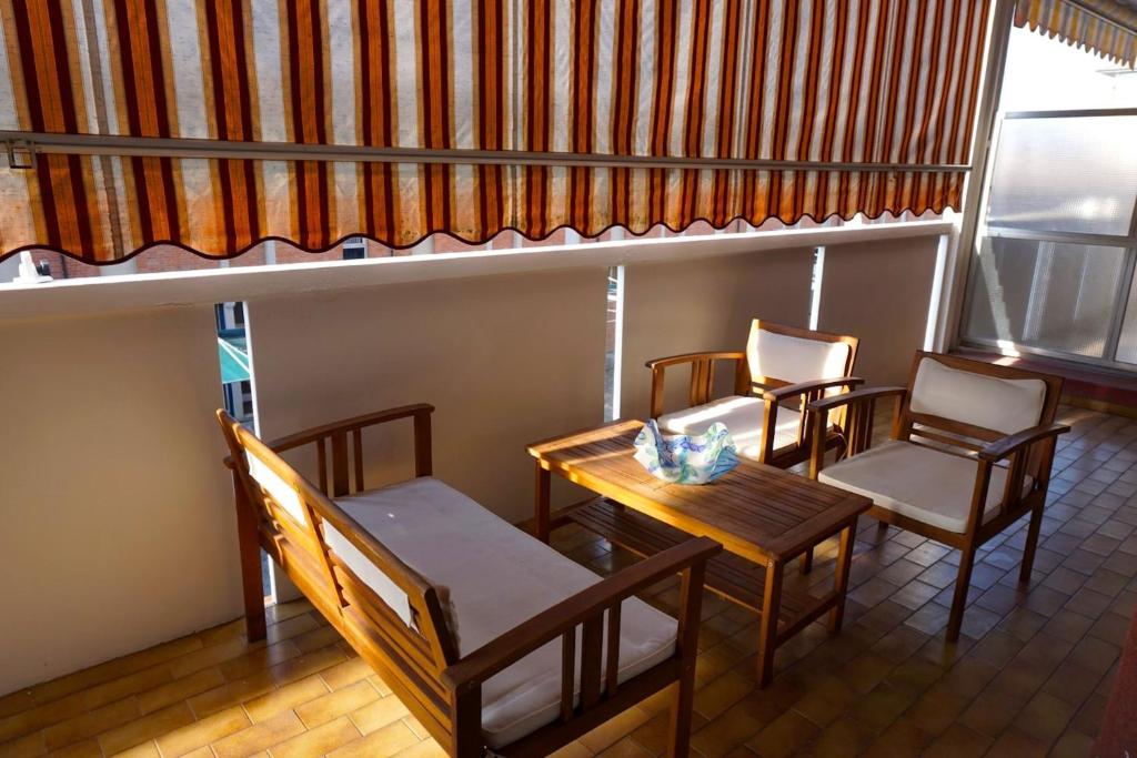 a room with a table and chairs and a window at Lovely flat with sunny terrace in Porto Santa Margherita di Caorle