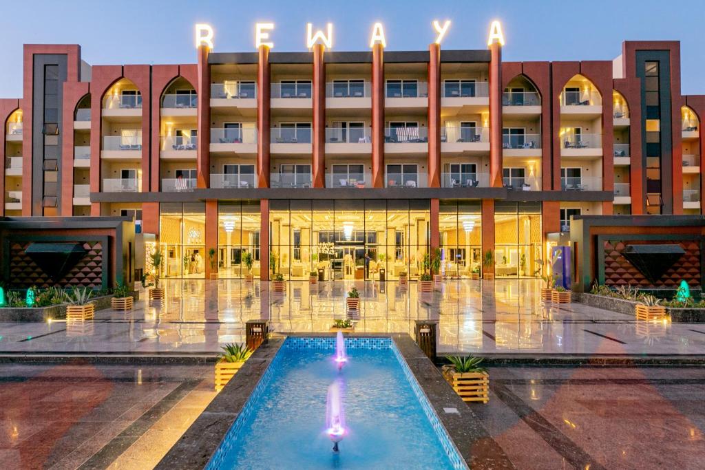 a hotel with a pool in front of a building at Rewaya Majestic Resort in Hurghada