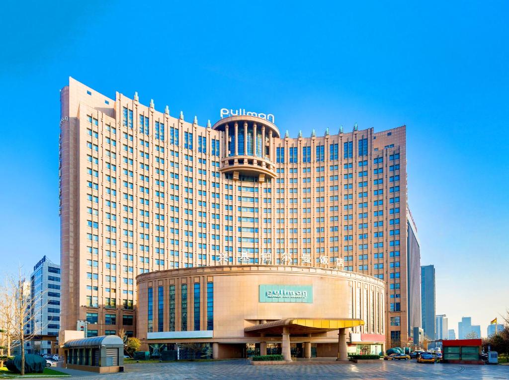 a large building with a sign on top of it at Pullman Beijing South in Daxing