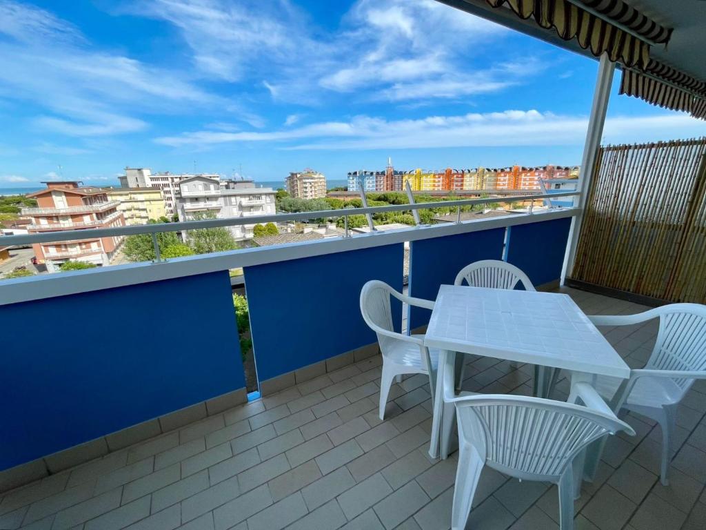 a white table and chairs on a balcony with a view at Comfy flat for four-Beahost in Porto Santa Margherita di Caorle