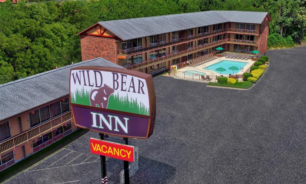 a wild bear inn sign in front of a building at Wild Bear Inn in Pigeon Forge