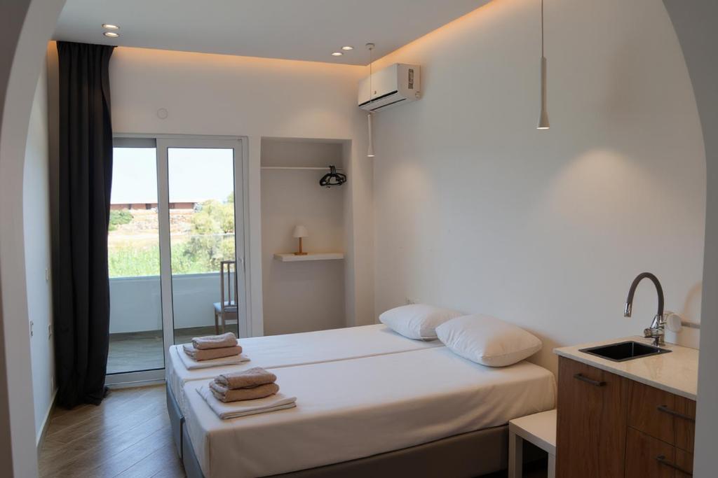 Ένα ή περισσότερα κρεβάτια σε δωμάτιο στο Ela Mare Sea View Apartments