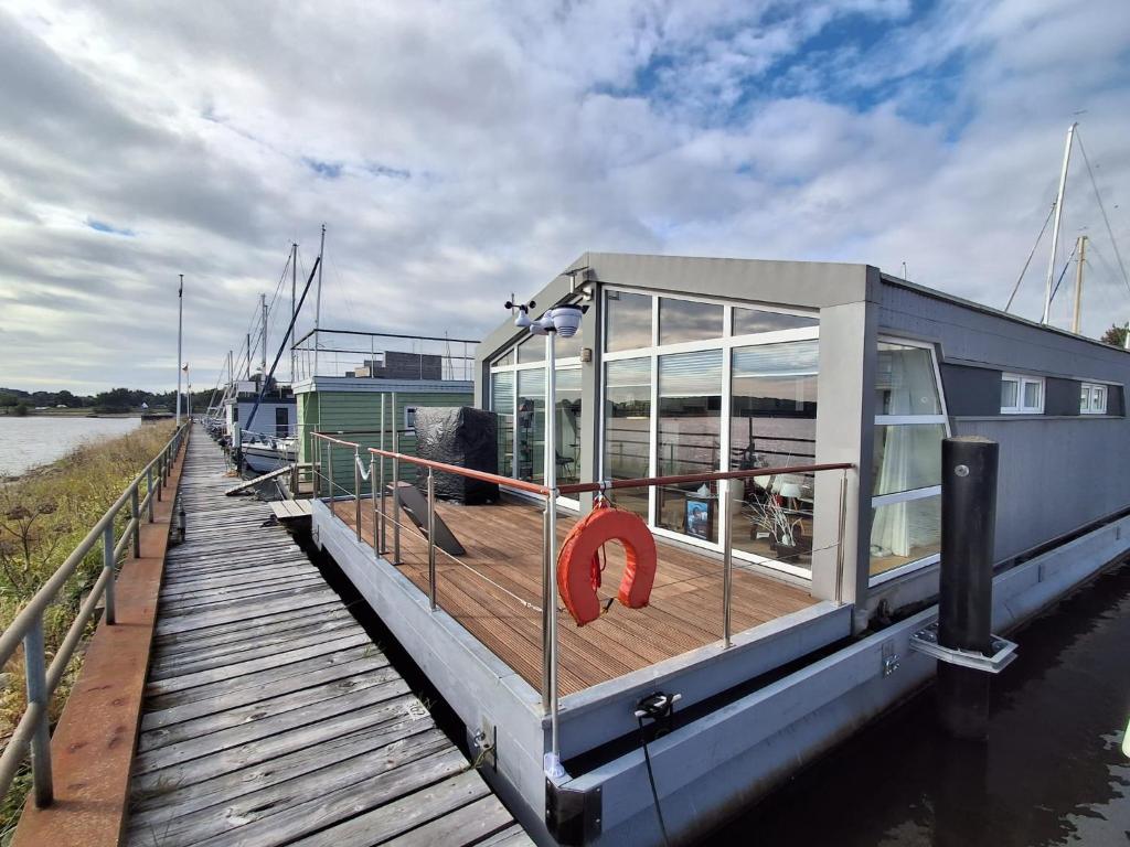 a boat is docked at a dock on the water at Schleiverliebt 52 in Schleswig