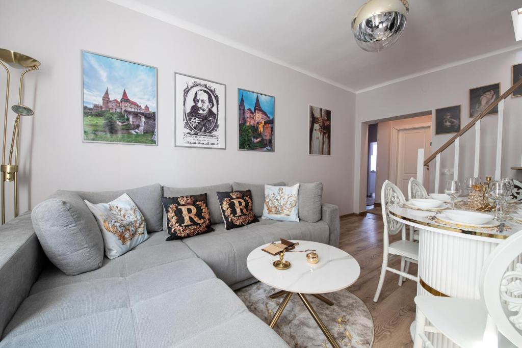 a living room with a couch and a table at The Royal House in Hunedoara