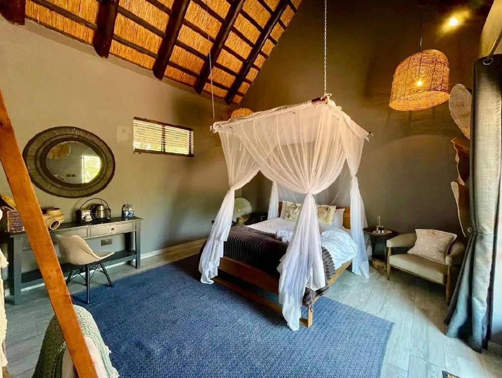 a bedroom with a bed with a mosquito net at Piers Villa G in Harare