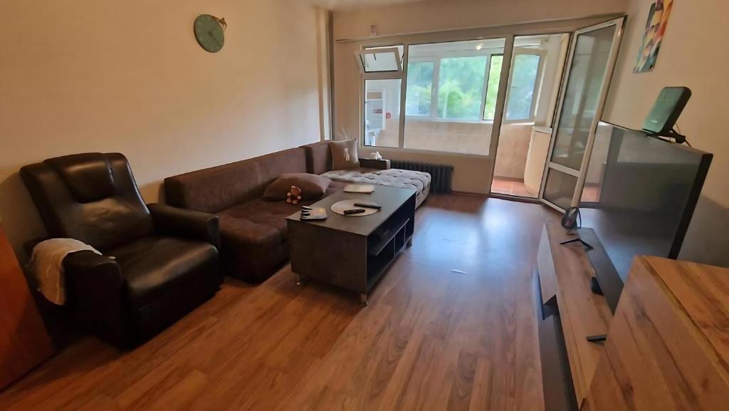 a living room with a couch and a table at Stylish Apt, Free Parking, Near Center & Airport in Varna City