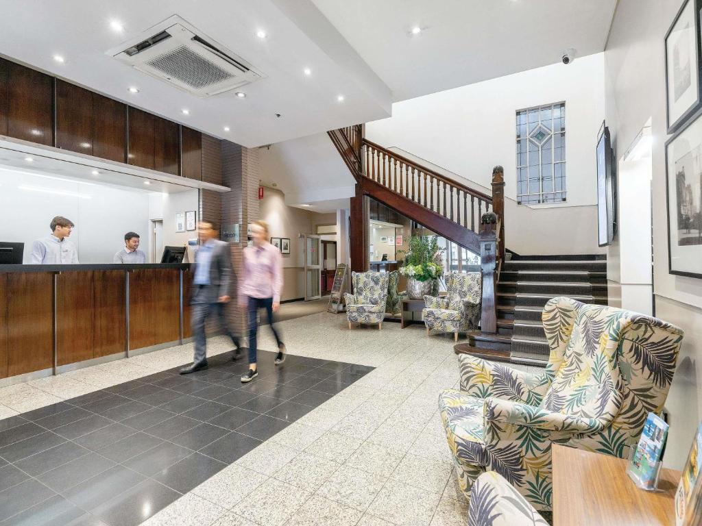 a group of people walking through a lobby at ibis Styles Kingsgate Melbourne in Melbourne