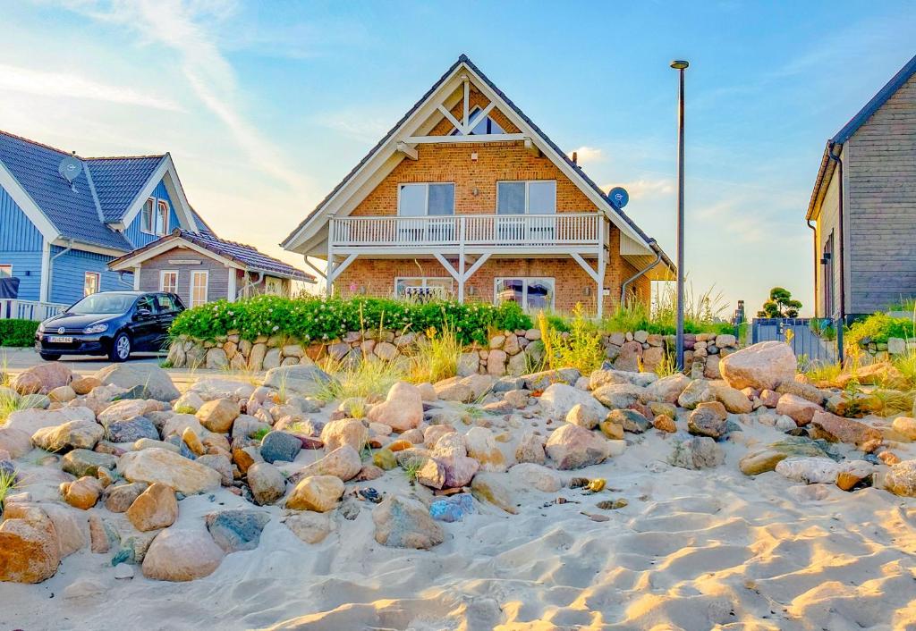 a house with a bunch of rocks on the beach at Ferienhaus Auf der Ostsee in Kappeln