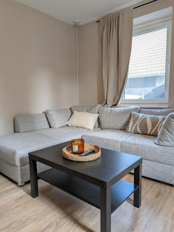 a living room with a couch and a coffee table at Ferienwohnung am Eifelsteig in Üxheim