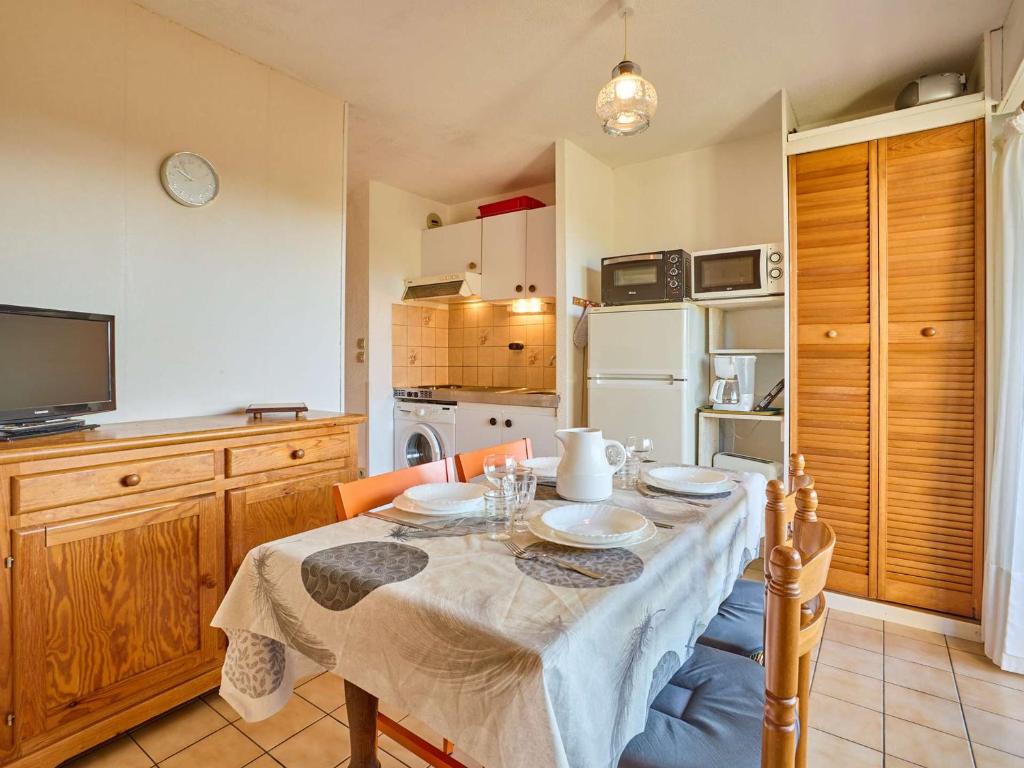 a kitchen with a table with a table cloth on it at T2 lumineux pour 2, animaux admis, parking, WiFi - FR-1-841-47 in Barbotan-les-Thermes