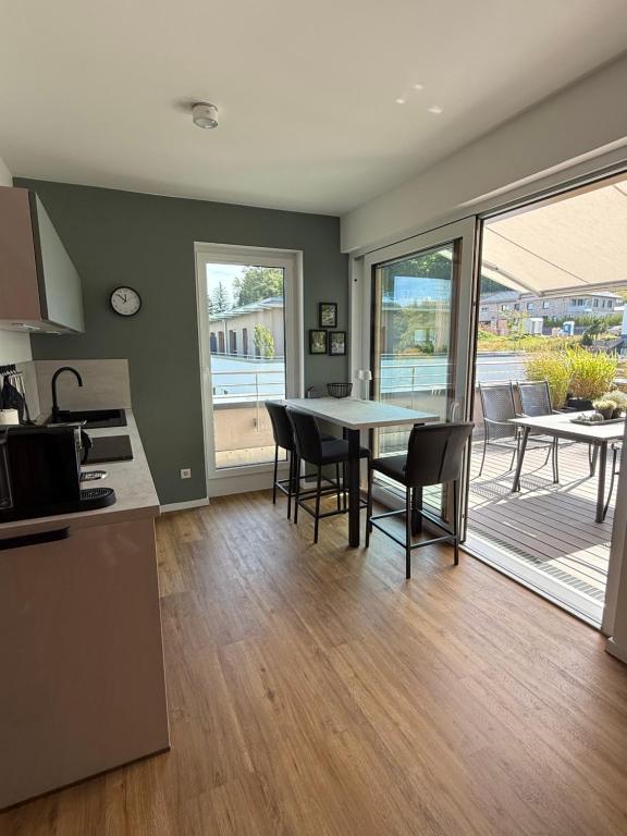 a kitchen and dining room with a table and chairs at Premium Penthouse Parkblick in Bad Driburg