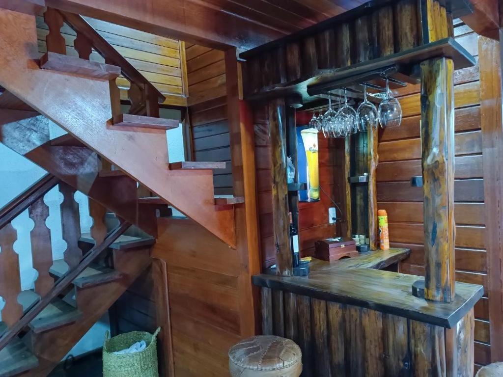 a staircase in a room with wooden walls at Casa de Temporada Allamanda in Água Boa