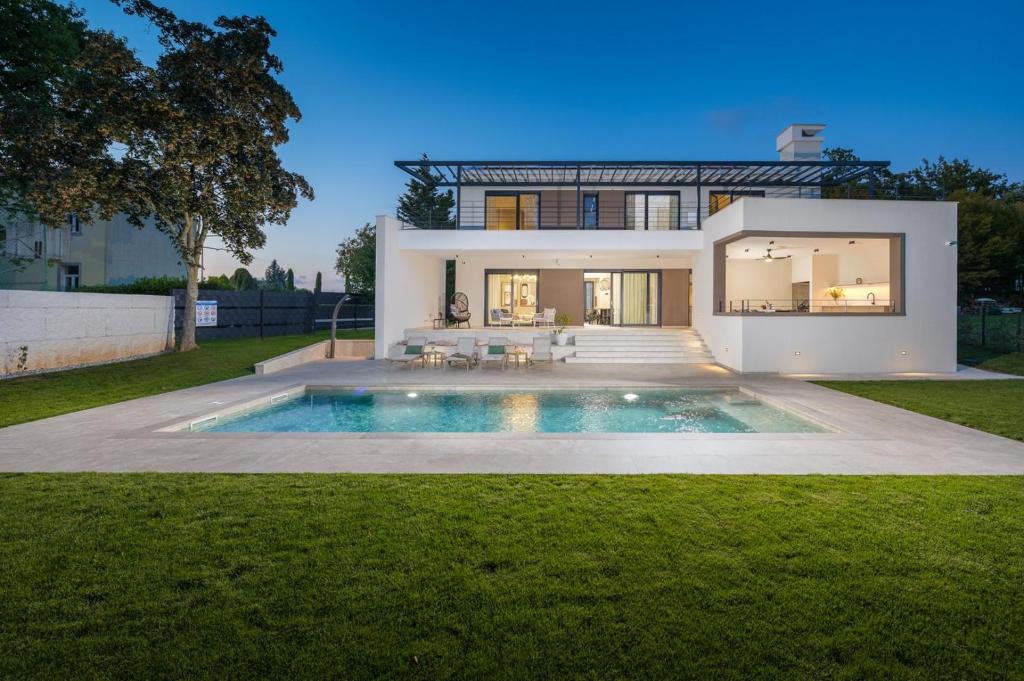 a house with a swimming pool in the yard at Villa Castanea by Villsy in Pazin