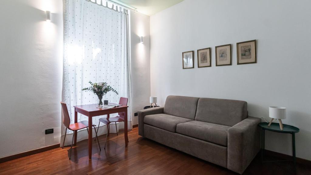 a living room with a couch and a table at Italianway - Tadino 1 B in Milan