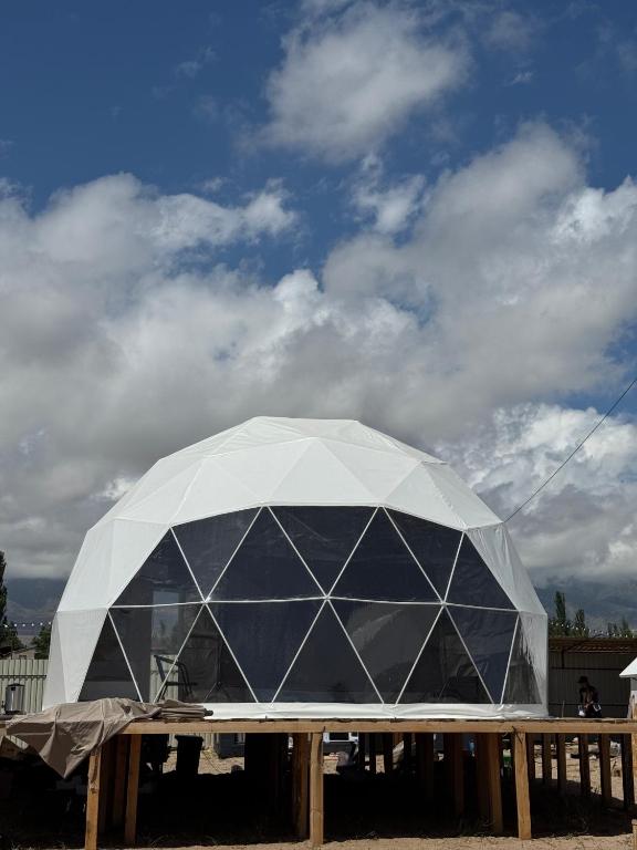 a large domed building with a sky in the background at Issyk-Kul Glamping in Chon-Sary-Oy