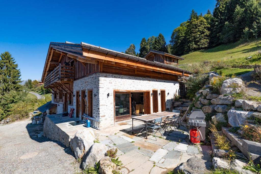 a log cabin with a picnic table in front of it at Le Chalet des Serves in Demi-Quartier