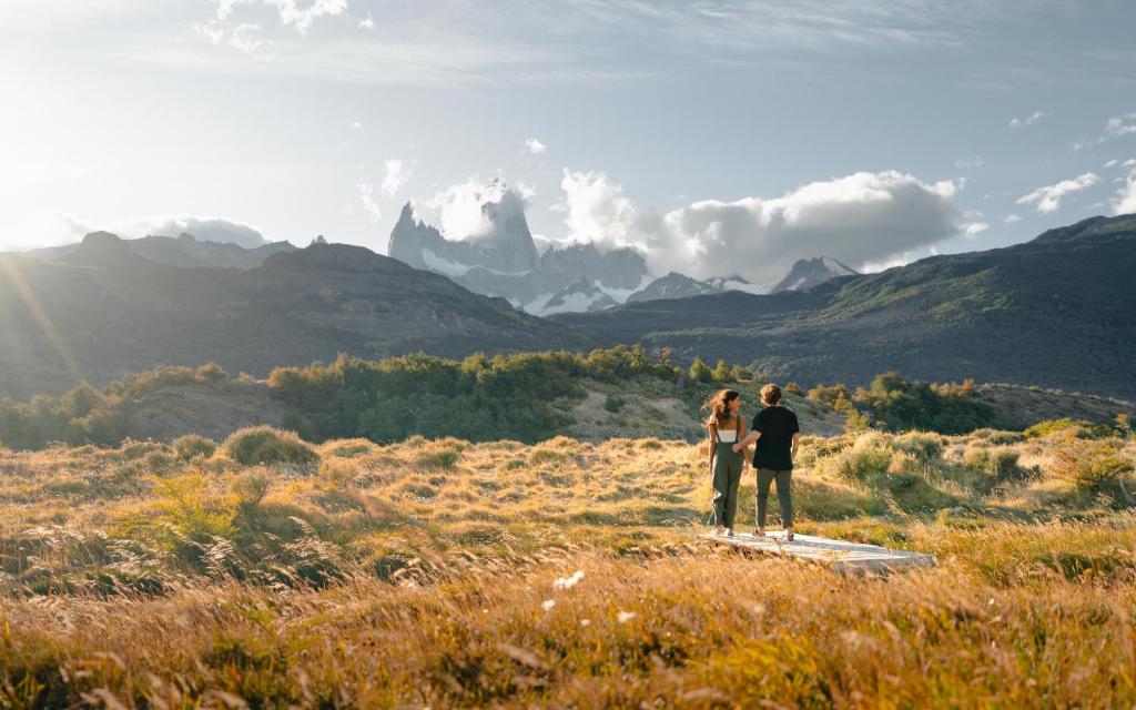 a man and woman standing on top of a mountain at Chalten Camp - Glamping with a view in El Chalten