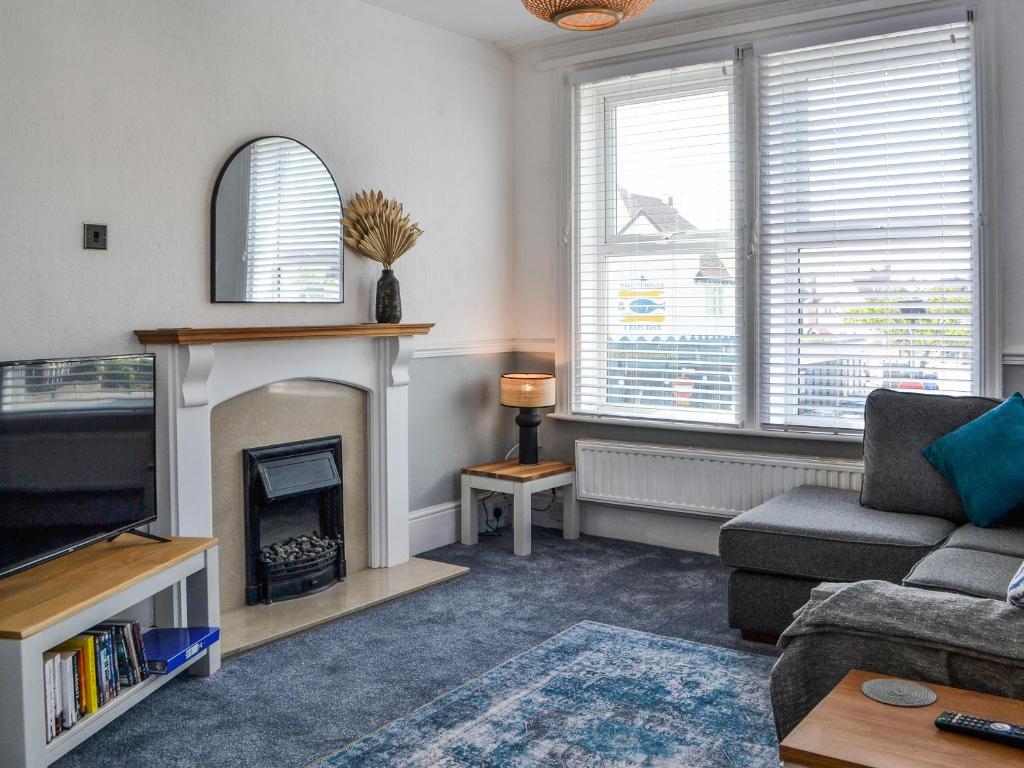 a living room with a tv and a fireplace at The Apartment in Filey