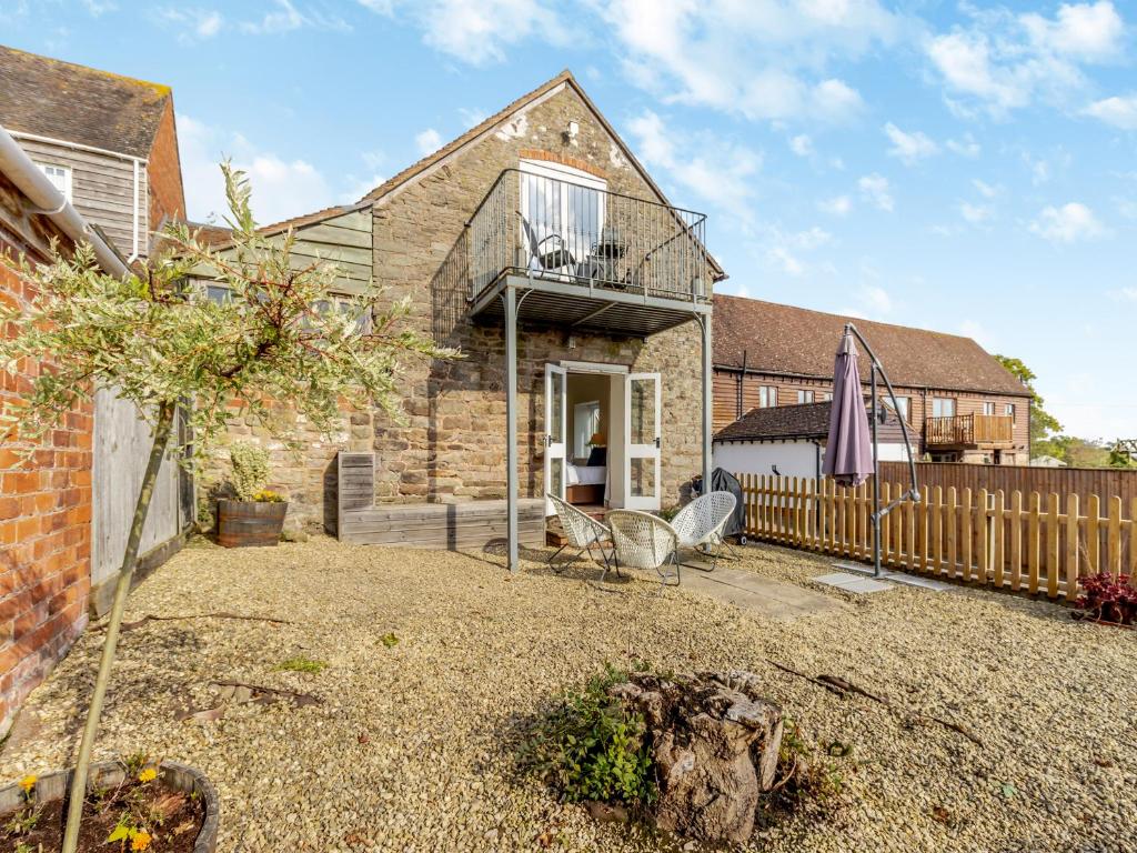 a brick house with a deck and a fence at Rambler's Hideaway - Uk45414 in Eaton Bishop
