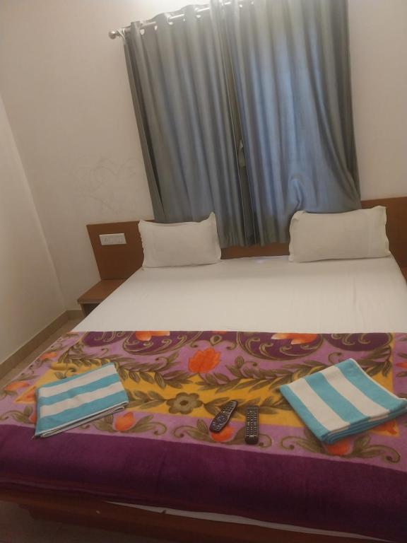 a large bed with two pillows at Naksh Villa in Mahabaleshwar