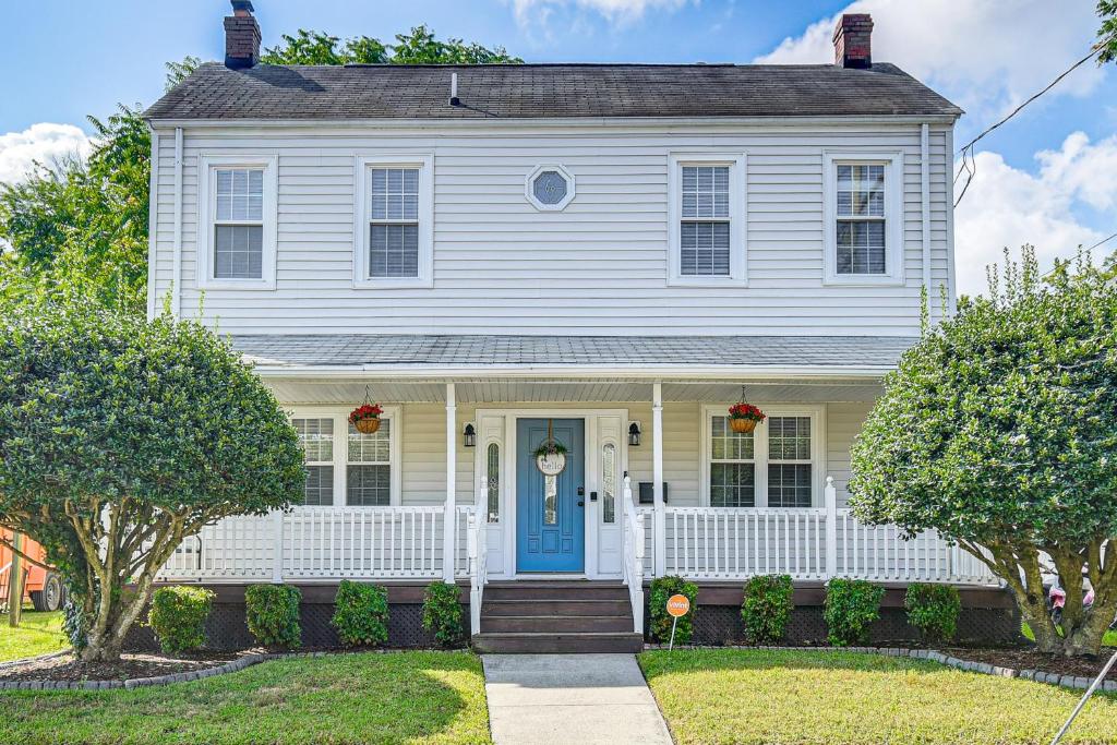 a white house with a blue door at Spacious Family Home with Yard in Dtwn Hampton! in Hampton