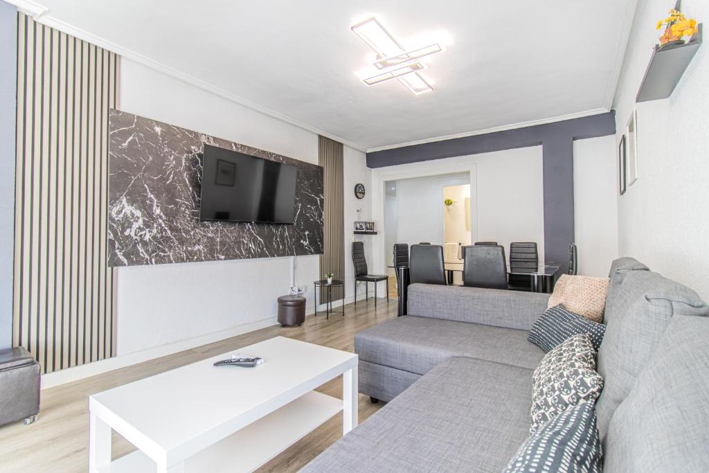 a living room with a couch and a table at Your Large Family Apartment in Zaragoza in Zaragoza