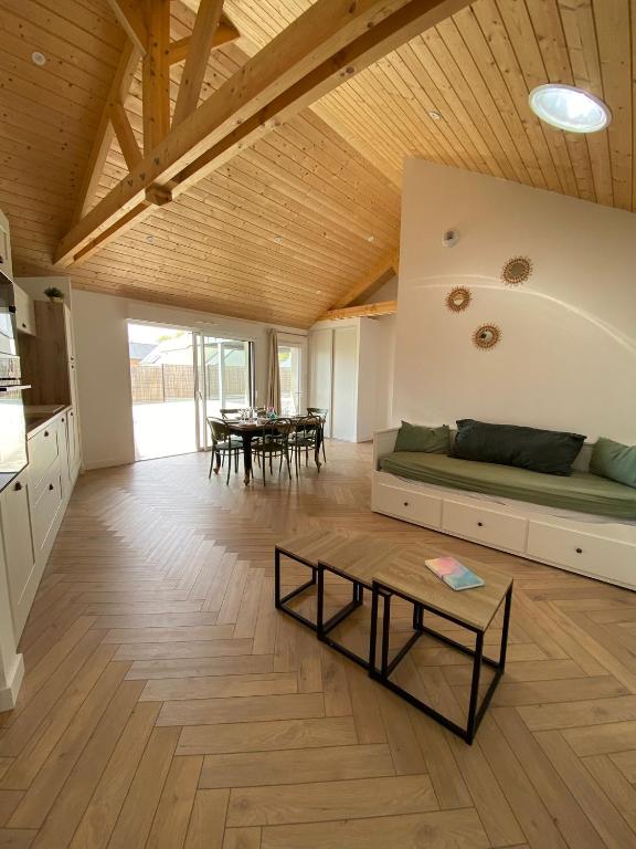 a living room with a couch and a table at L'Escale - Charming Seaside house by Harbor in Cancale