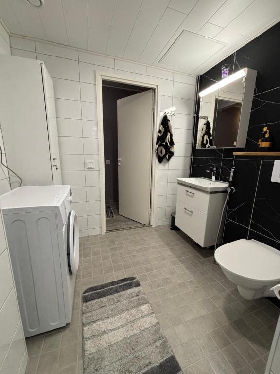a bathroom with a toilet and a sink at Stylish two-rooms and kitchen apartment 66 m2 in Turku