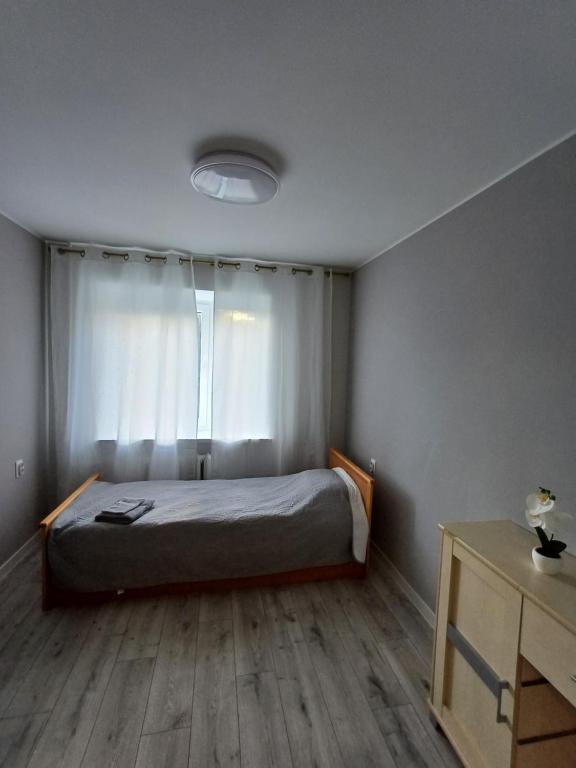 a bedroom with a bed and a window at Narva mnt 26 in Jõhvi
