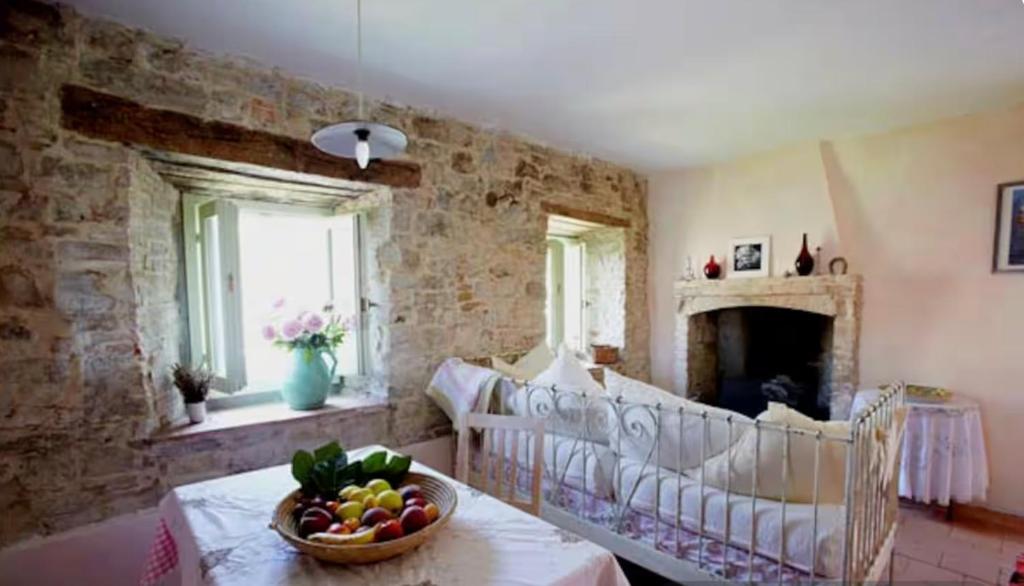 a living room with a table with a bowl of fruit at Country House Ca di siro in Gazola
