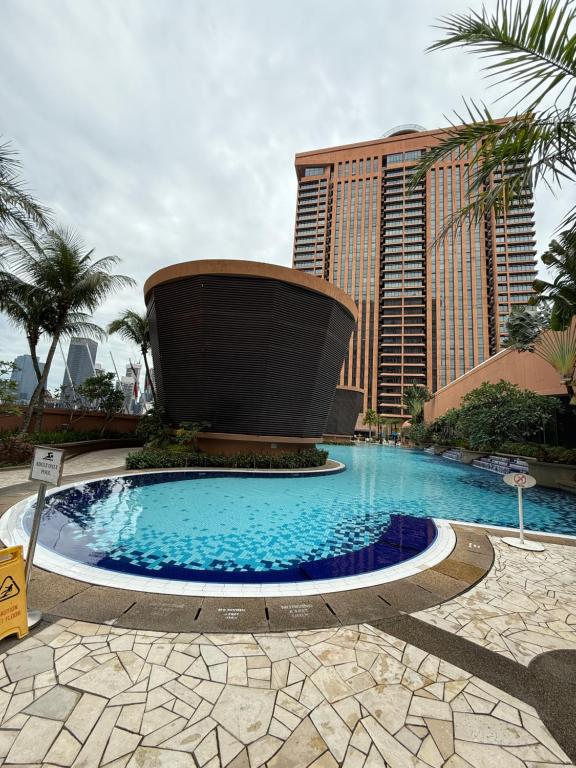 a large swimming pool in front of a tall building at Times Square KL Serviced Suite in Kuala Lumpur