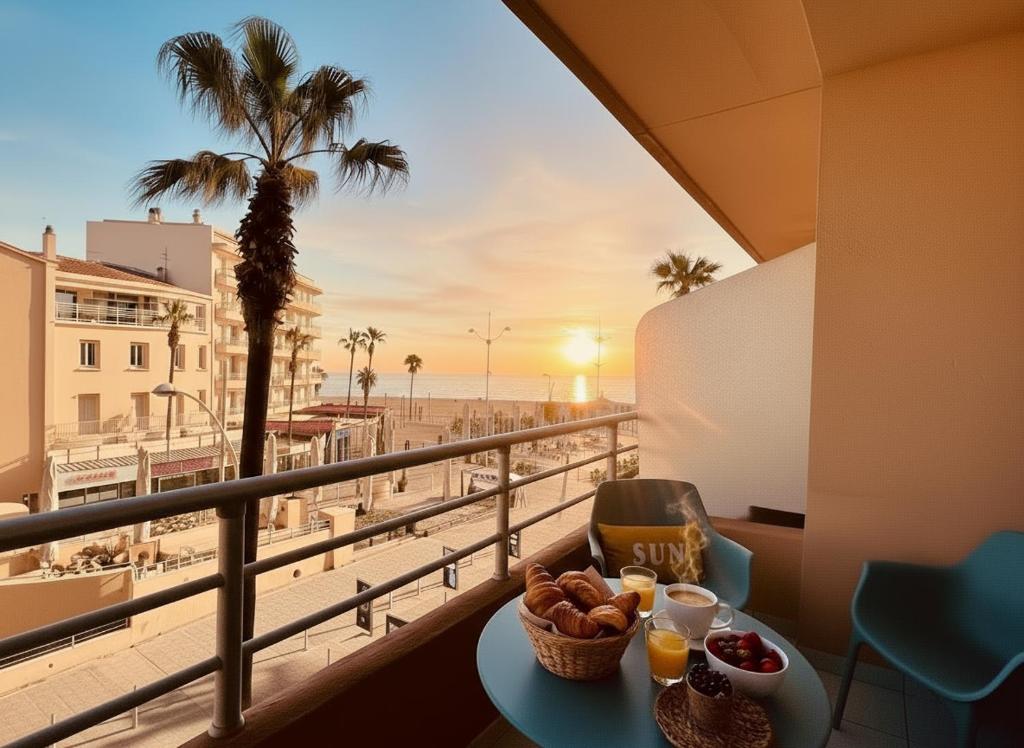 a table with food on a balcony with a view of the beach at Superbe T2 vue mer avec ascenseur 22 in Canet-en-Roussillon