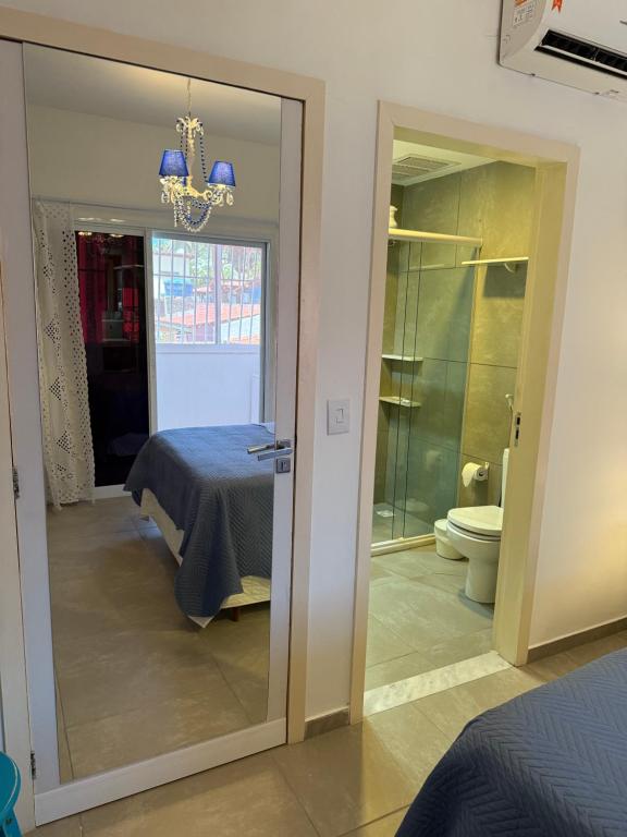 a bedroom with a bed and a glass door at Pipa Magnólia Suite in Pipa