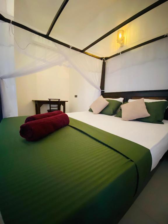 a bedroom with a large bed in a tent at Reefline Villa in Weligama