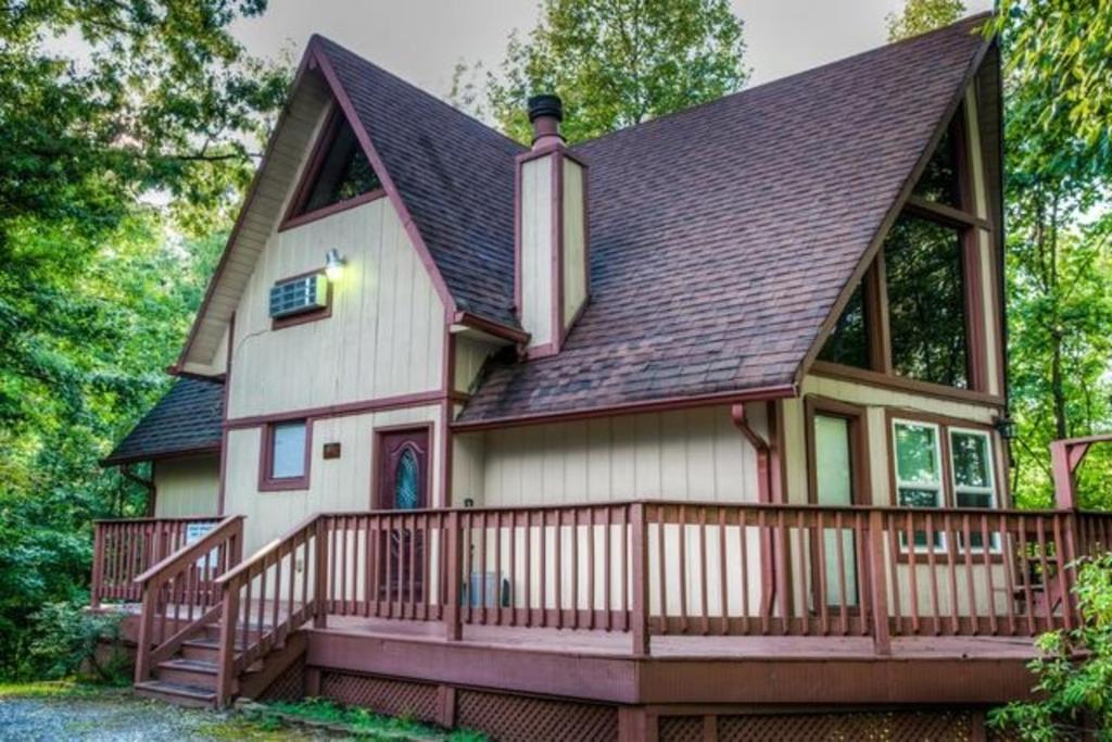 a large white house with a large deck at Gatlinburg Mountain Cabin with Modern Comforts in Chalet Village