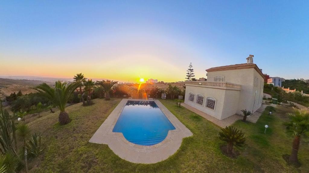 an aerial view of a house with a swimming pool at Luxury Villa 4-Bedroom Estate with Panoramic Tanger Bay Sea View, Private Pool, Garden in Noûnouech