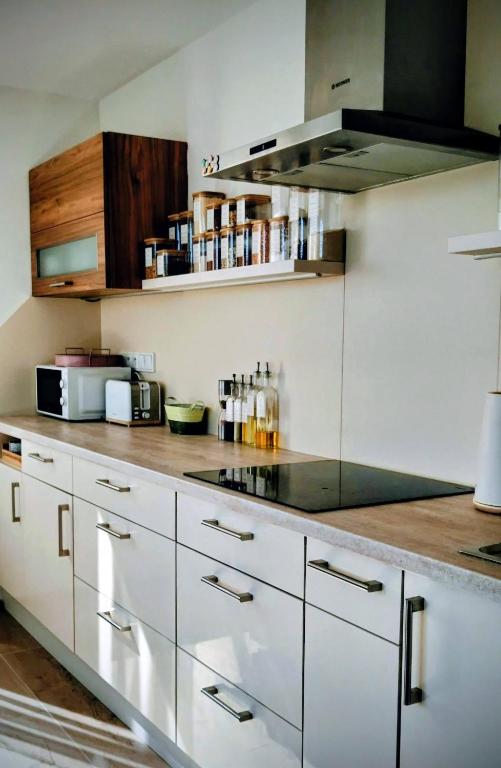 a kitchen with white cabinets and a counter top at Apartmán Slunečná in Moravská Třebová