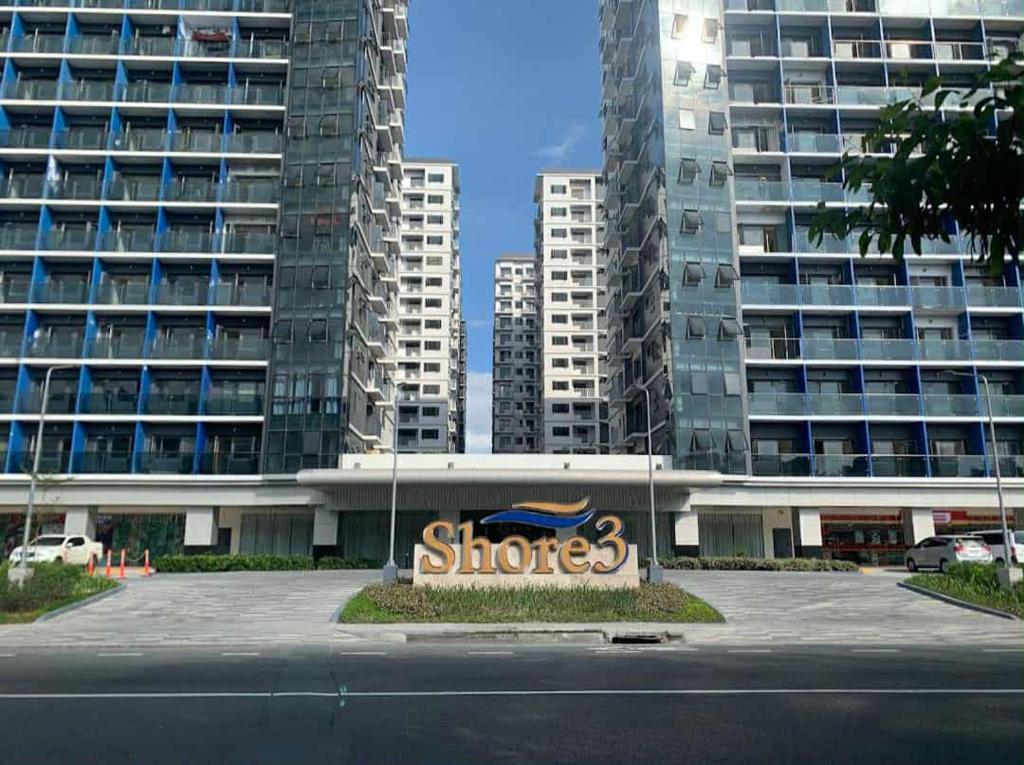 a stores sign in front of some tall buildings at SkyShore in Manila