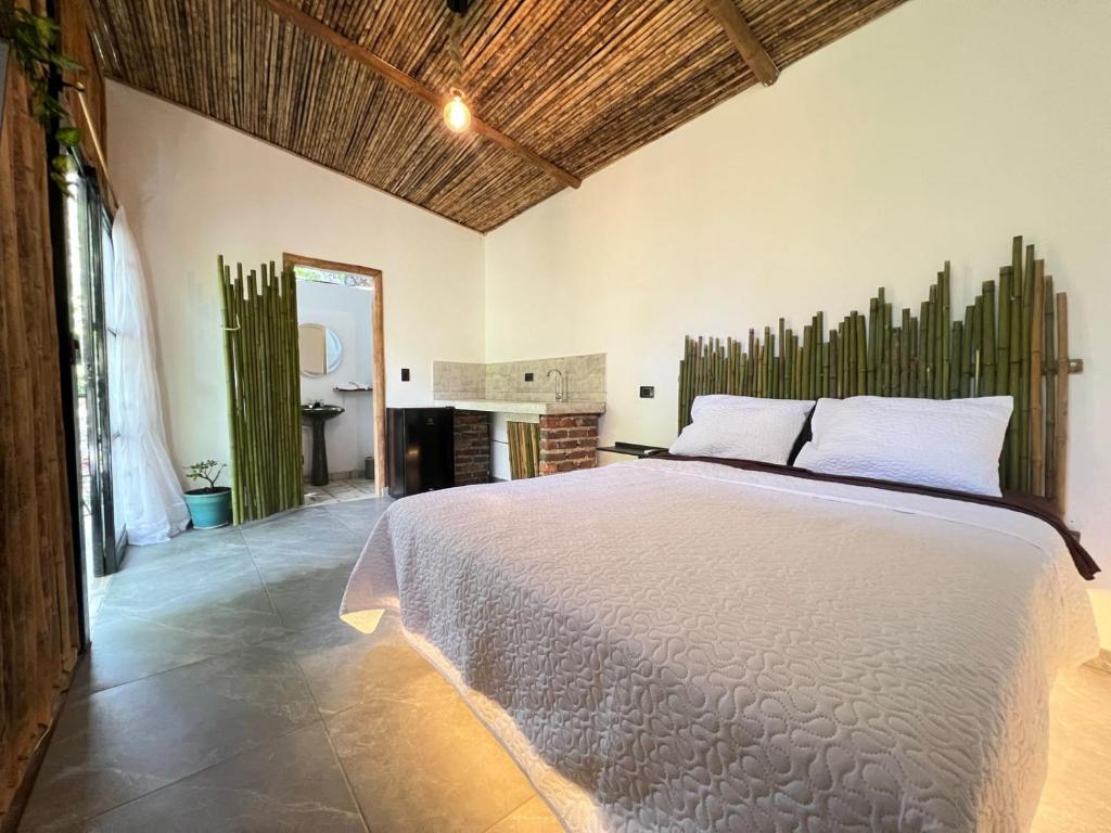a bedroom with a large bed and a fireplace at Balcones del Rio Tobia in Nimaima