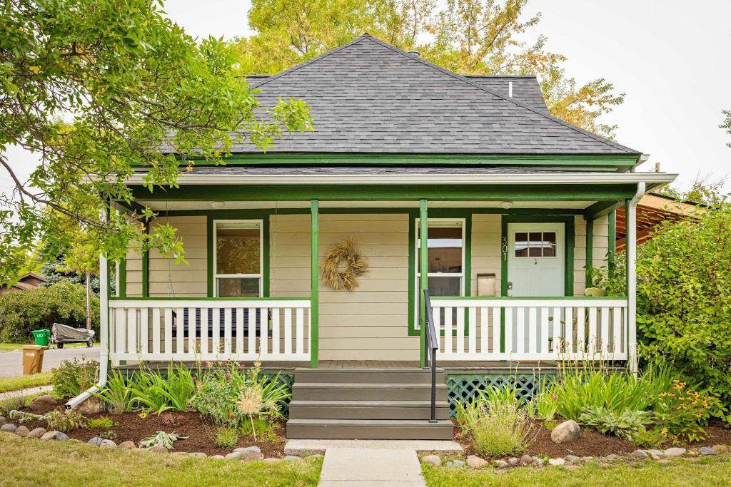 a small green house with a white porch at North Bozeman Oasis in Bozeman