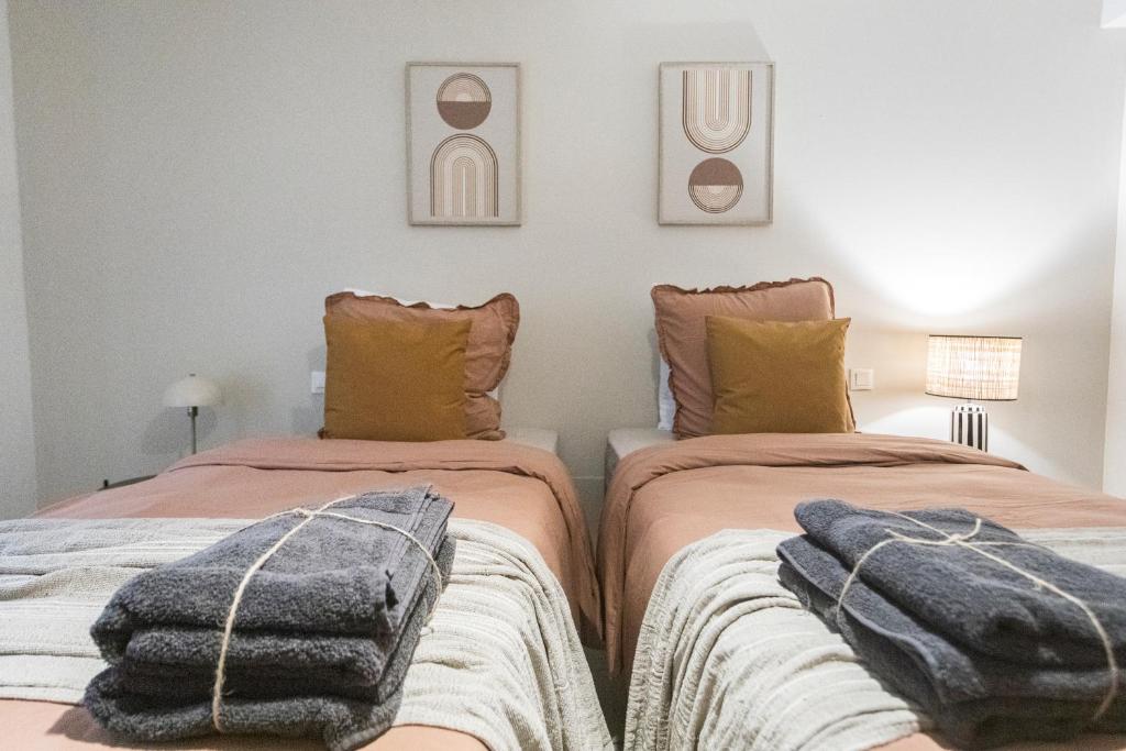 two beds sitting next to each other in a room at Loft Station Parking Video Projector near Tours in Saint-Pierre-des-Corps